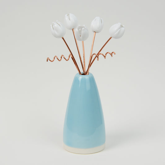 Miniature blue porcelain cone shaped vase with white glass tulips