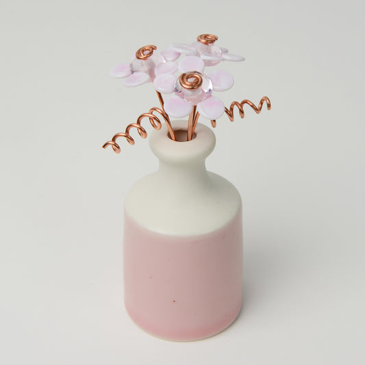 Miniature pink porcelain bottle vase with pink glass daisies