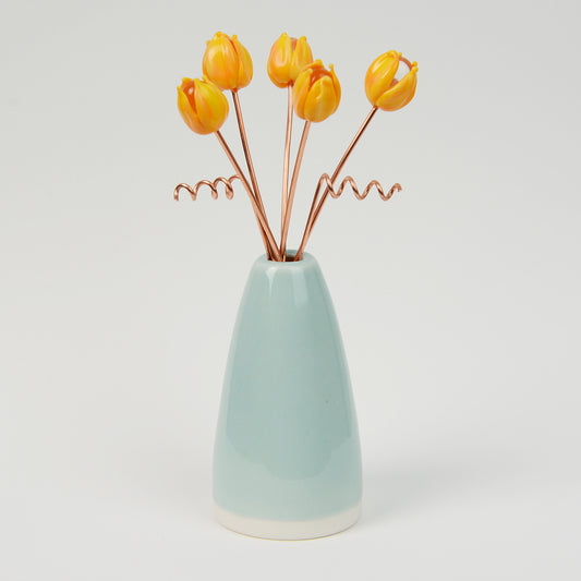 Miniature pale teal porcelain cone vase with yellow glass tulips