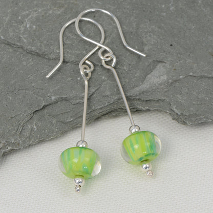 Encased green glass bead earrings